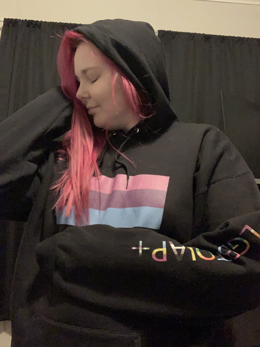 person wearing a black hoodie with bisexual flag
